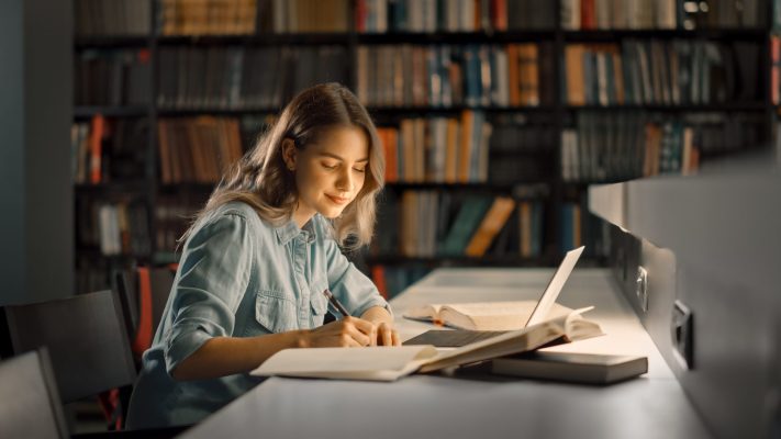 University Library: Beautiful Smart Caucasian Girl uses Laptop,